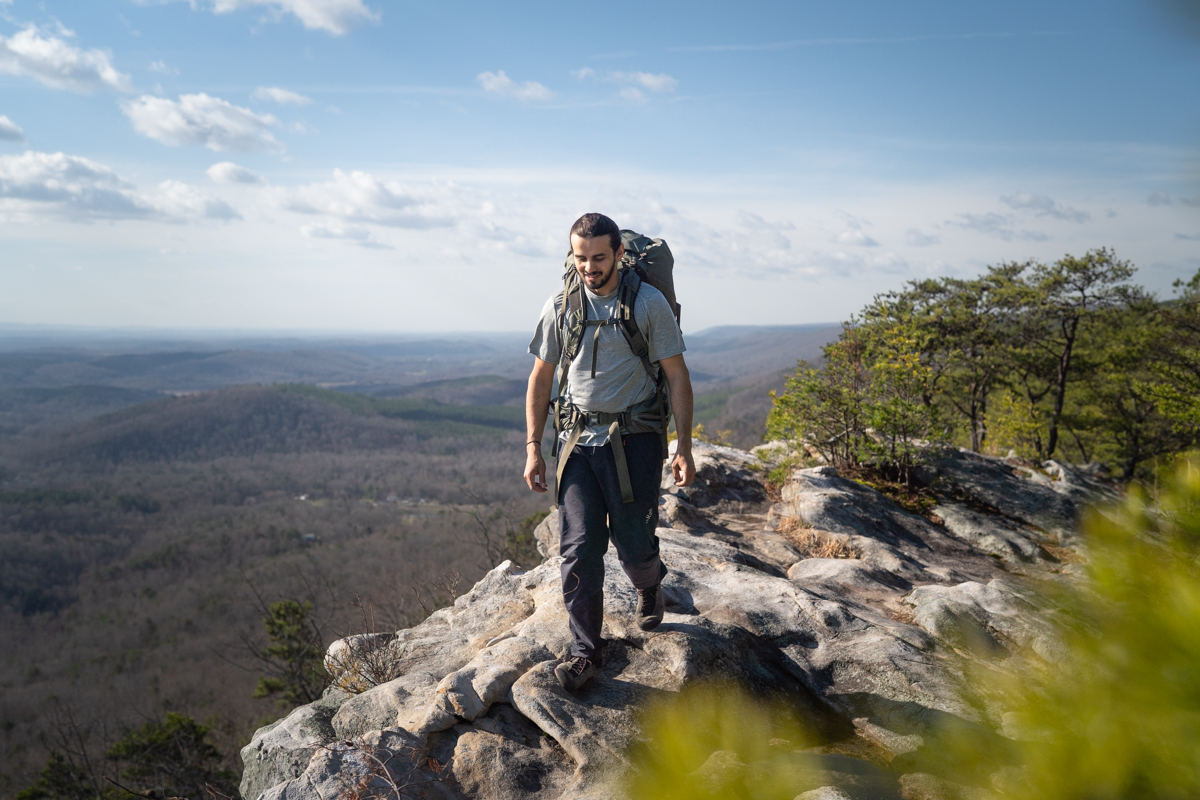 A hiker wearing a grey Patagonia Capilene Cool Daily shirt while backpacking near Chattanooga.
