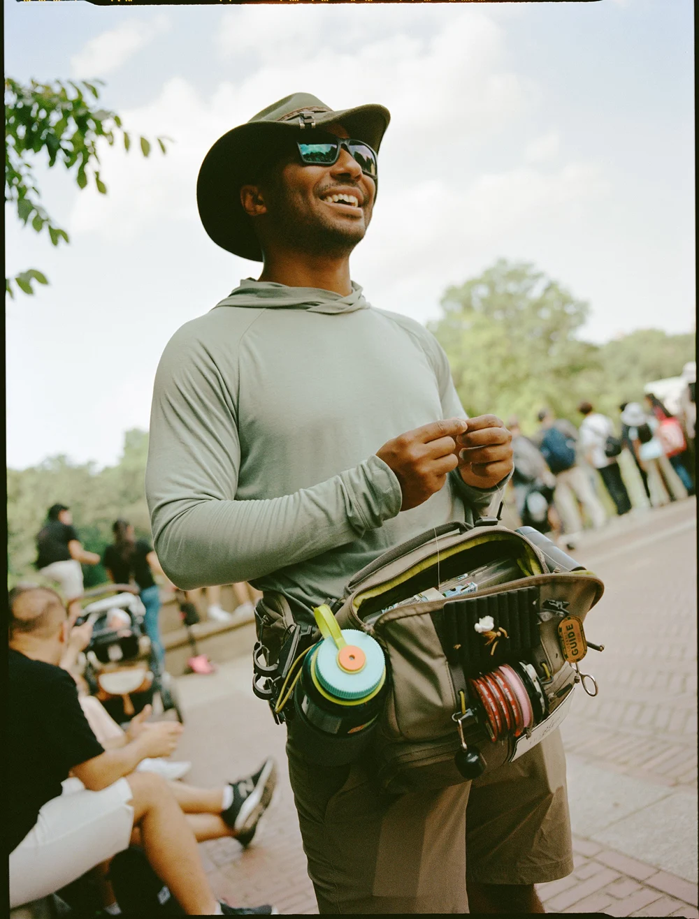 Dr. Brandon Dale holding a large common carp caught while fly fishing in Central Park.