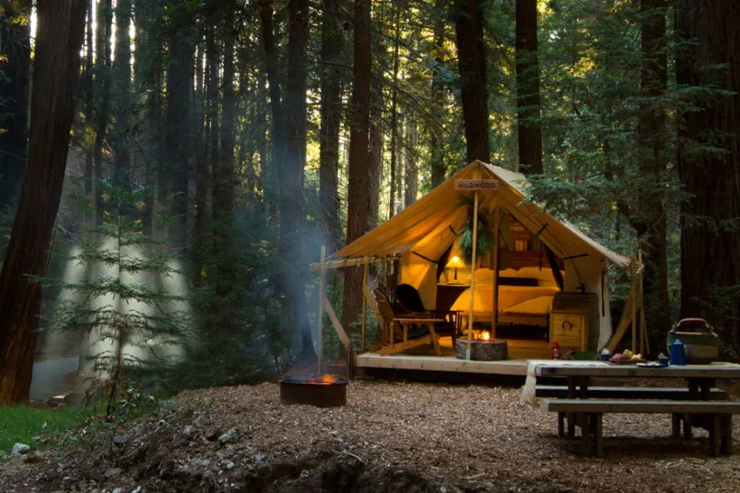 Exterior view of a luxury safari-style tent at Ventana Big Sur overlooking hills.