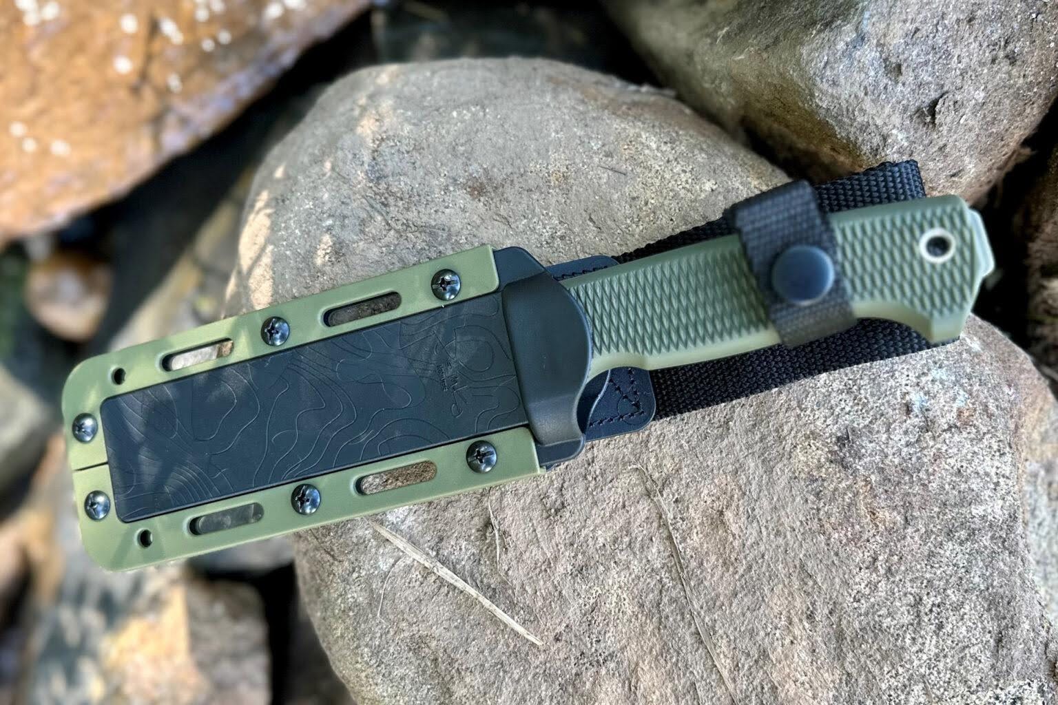 A bushcraft knife secured in a belt sheath during an outdoor hike.