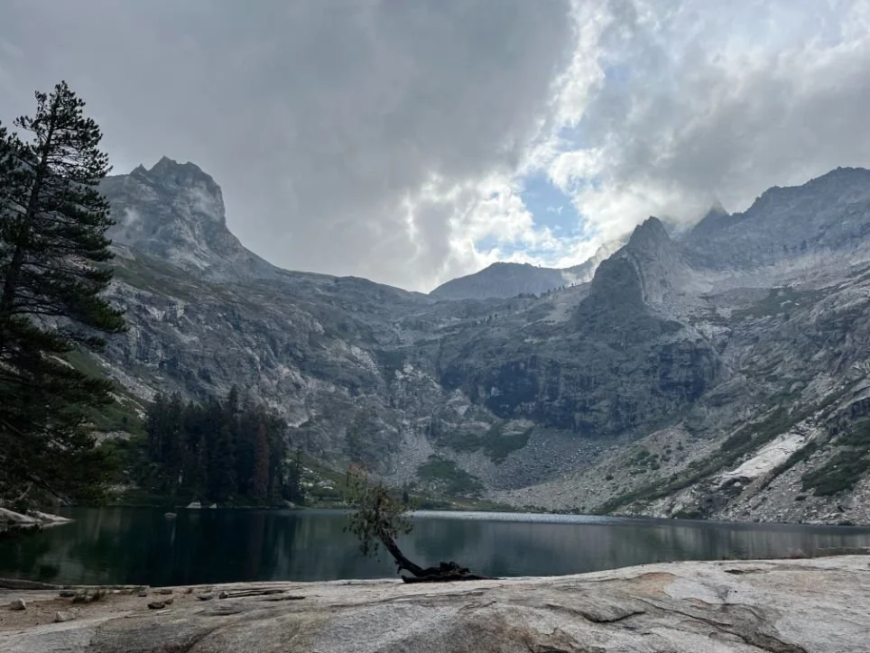 A panoramic view of Hamilton Lakes on a cloudy day, nestled below high granite peaks.
