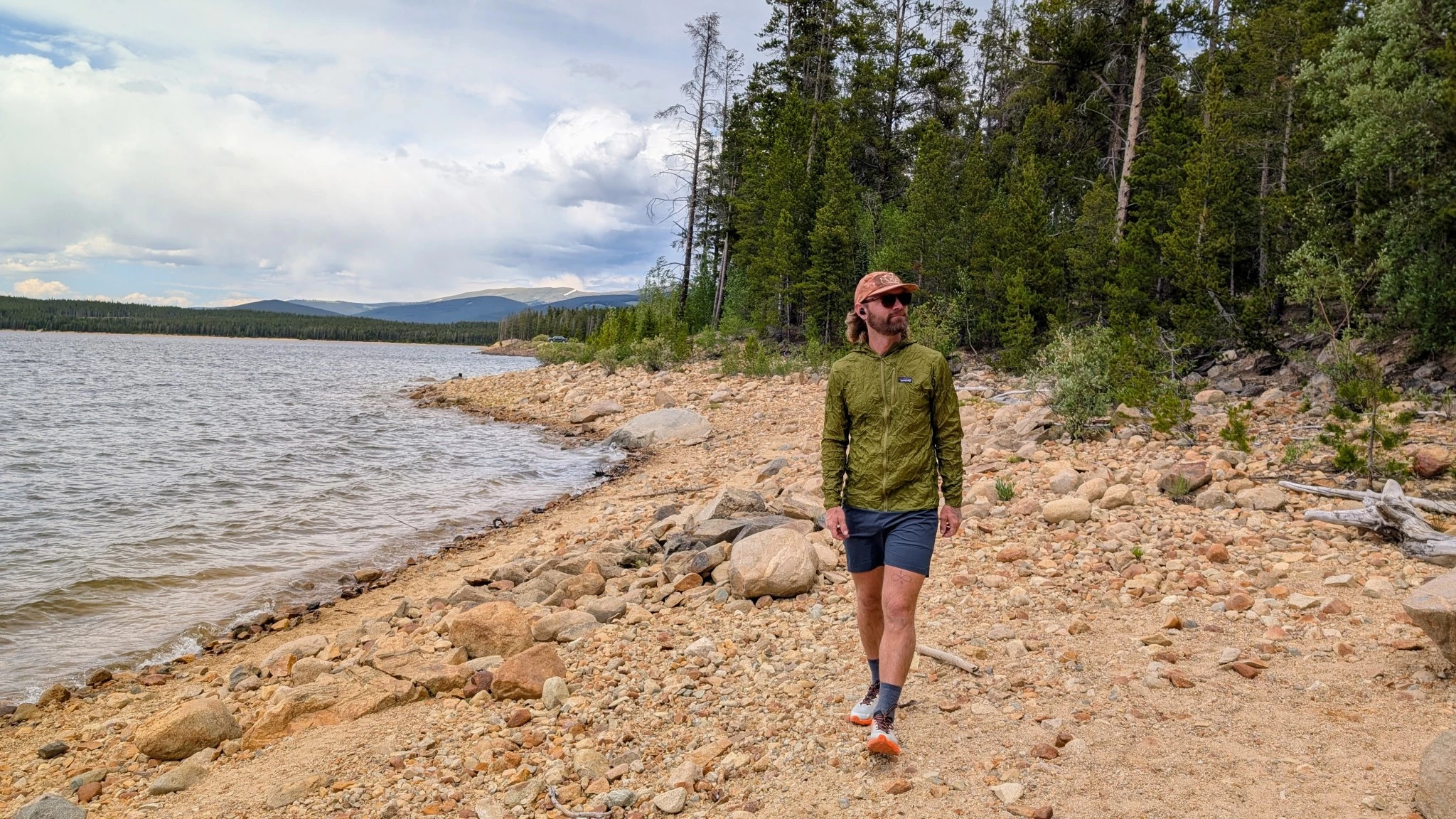 A person wearing a Patagonia Houdini jacket in a casual setting after a day of activity.