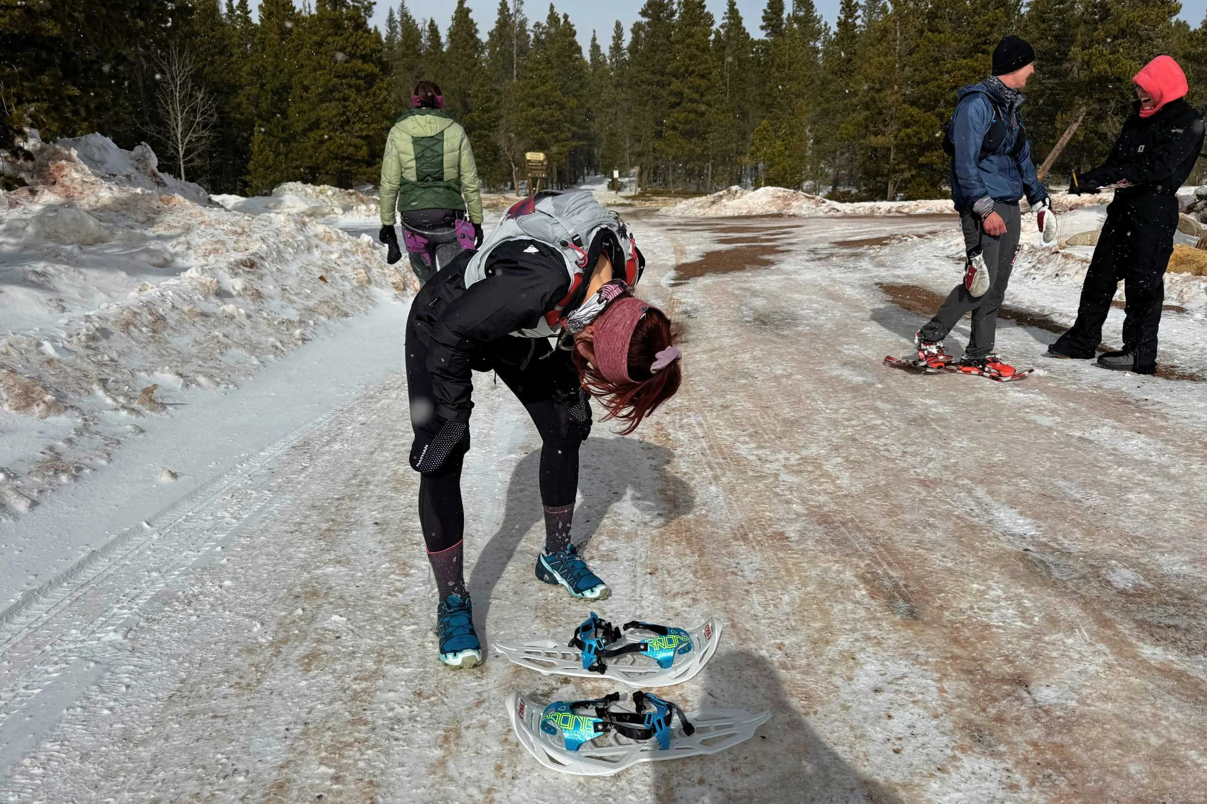 An exhausted runner catching their breath in the snow after a long race.