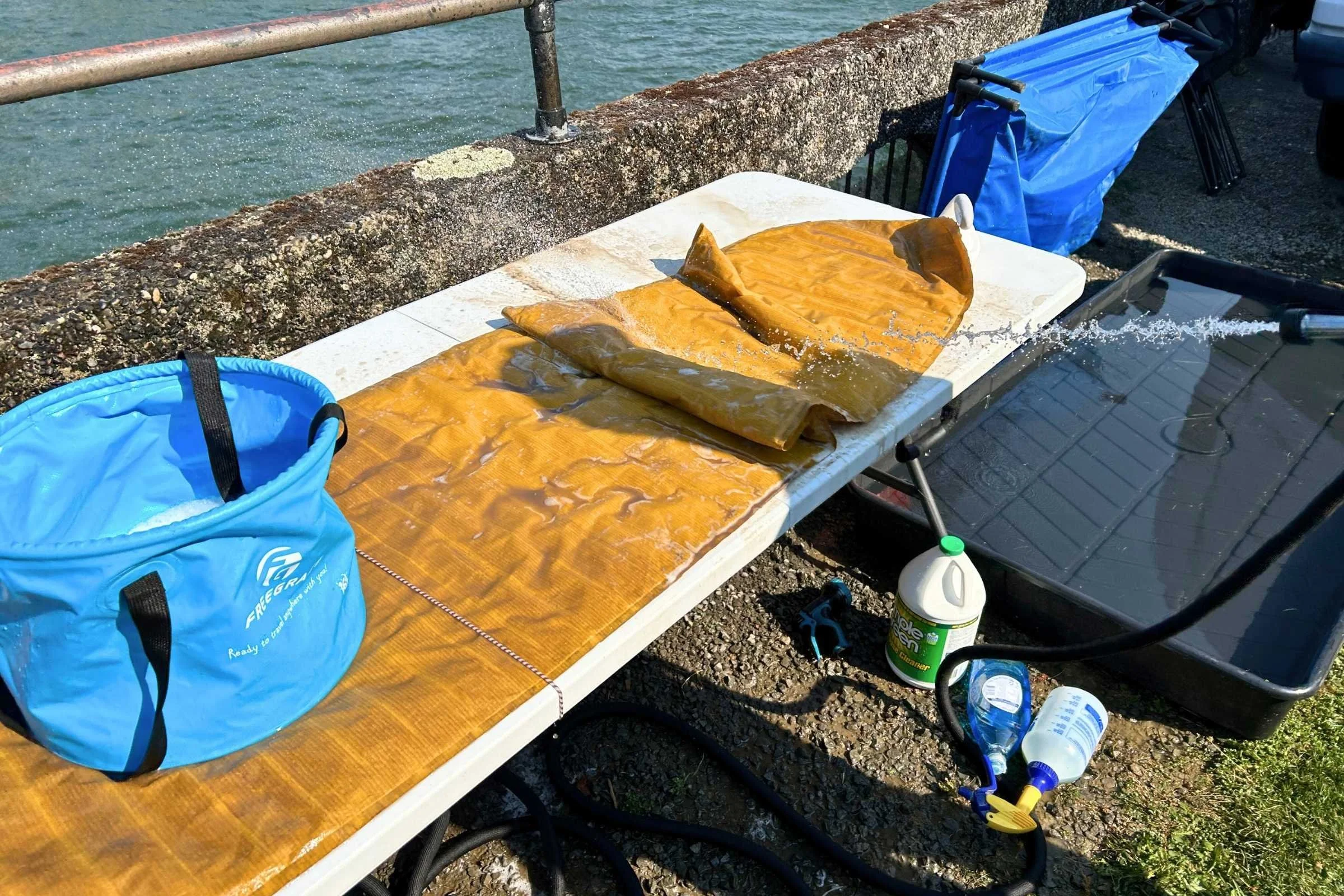 Side-by-side comparison of a dirty sleeping pad and a scrubbed portion showing the restored fabric color.