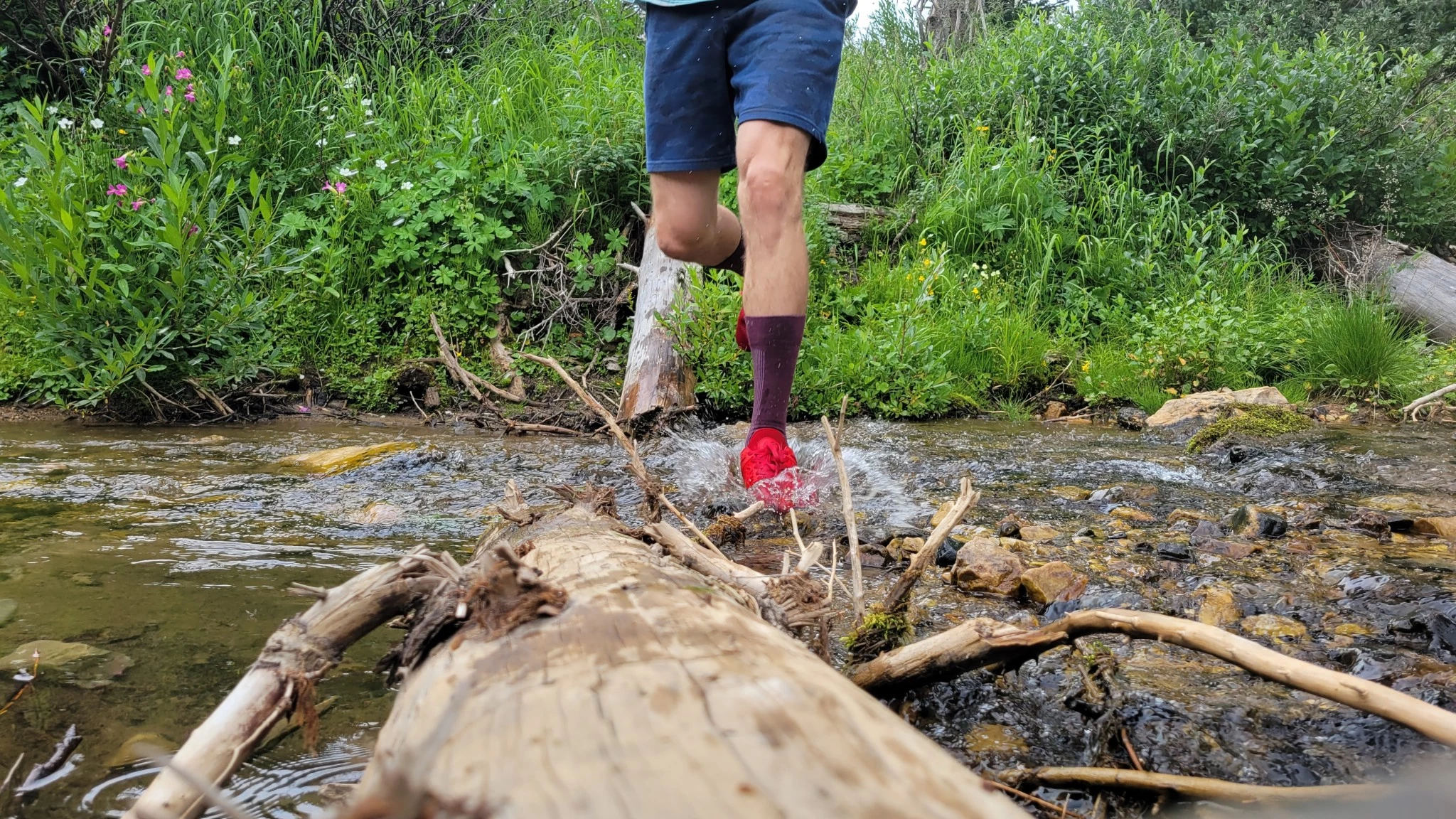 Performance socks being tested in a wet and muddy outdoor environment.