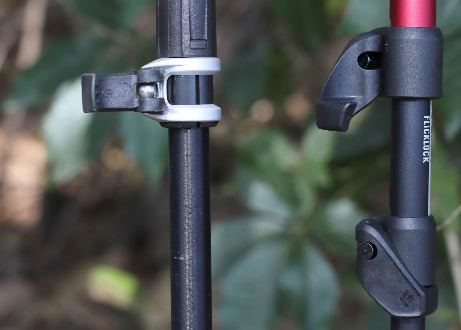 Detailed view of lever lock and flick lock mechanisms on trekking pole shafts.