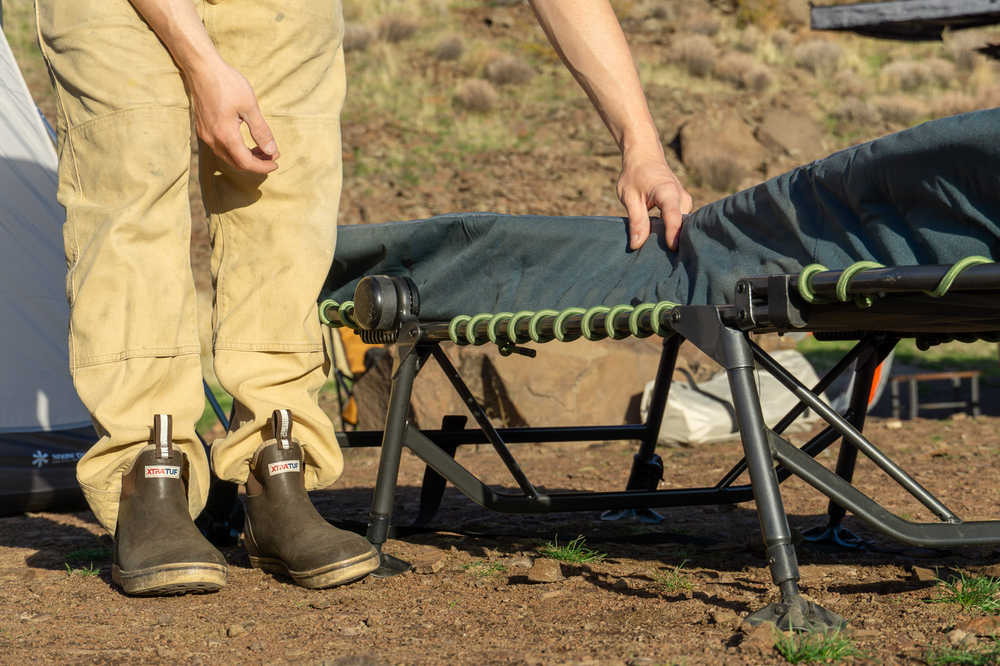 A close-up view of the author lifting the padded surface to reveal the shock cord suspension system.