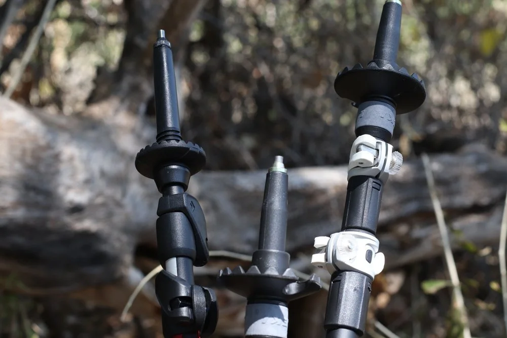 An array of trekking pole accessories including various baskets and rubber tips.