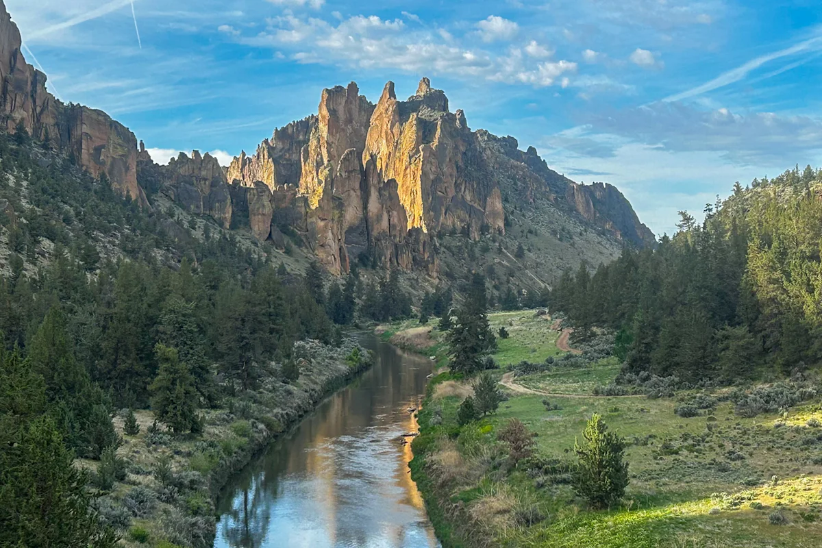 The towering orange volcanic tuff cliffs of Smith Rock State Park rising above the Crooked River.