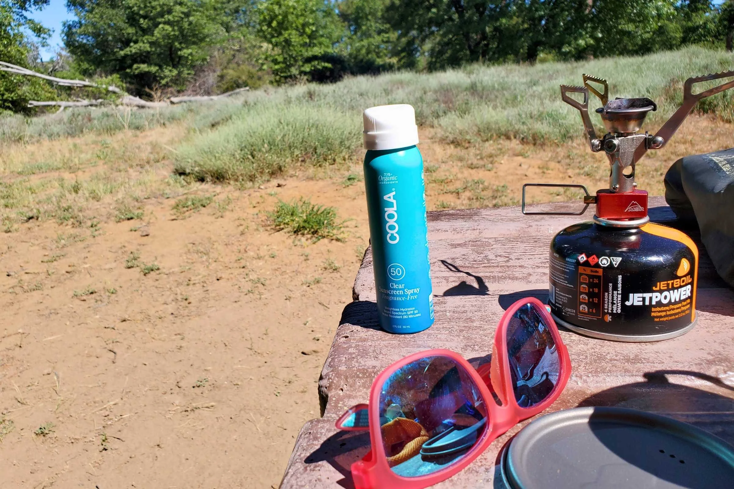 A collection of spray sunscreens being tested in various outdoor environments.