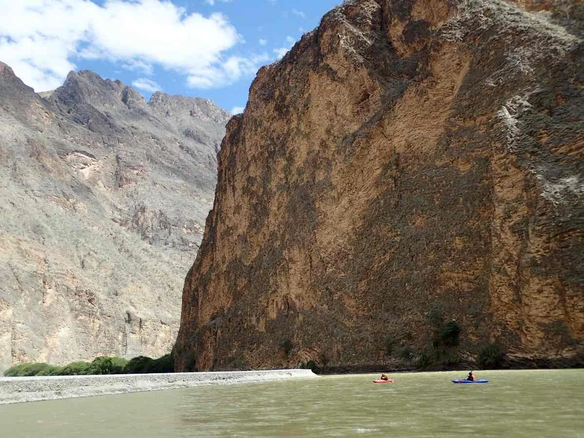 The author paddling a small boat in the vast Rio Maranon in Peru.