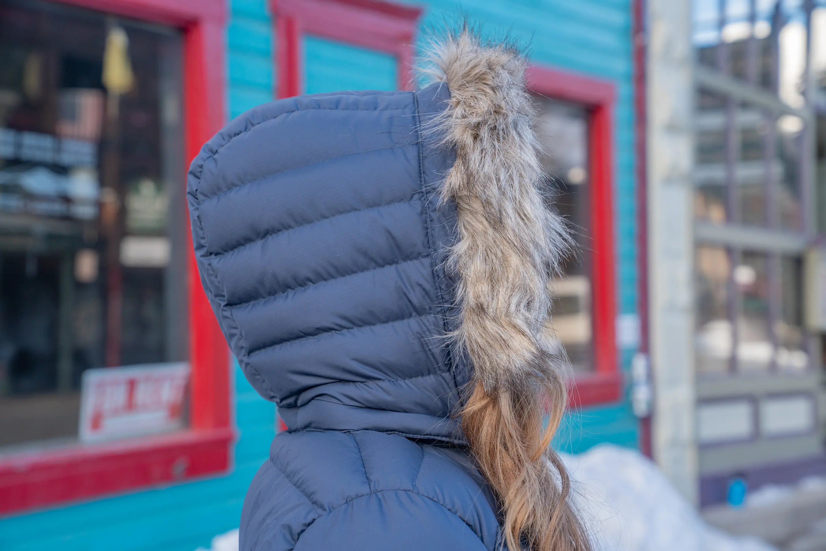 Side profile of an insulated hood with faux fur on a winter parka