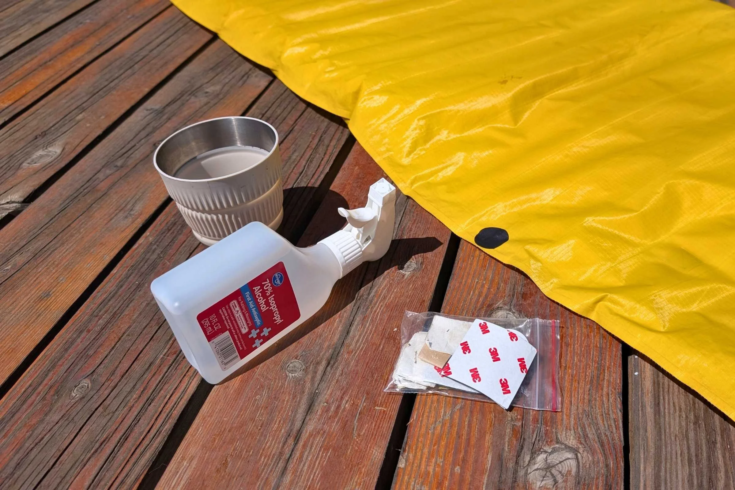 Alcohol prep pads, patches, and adhesive kits laid out for a repair.