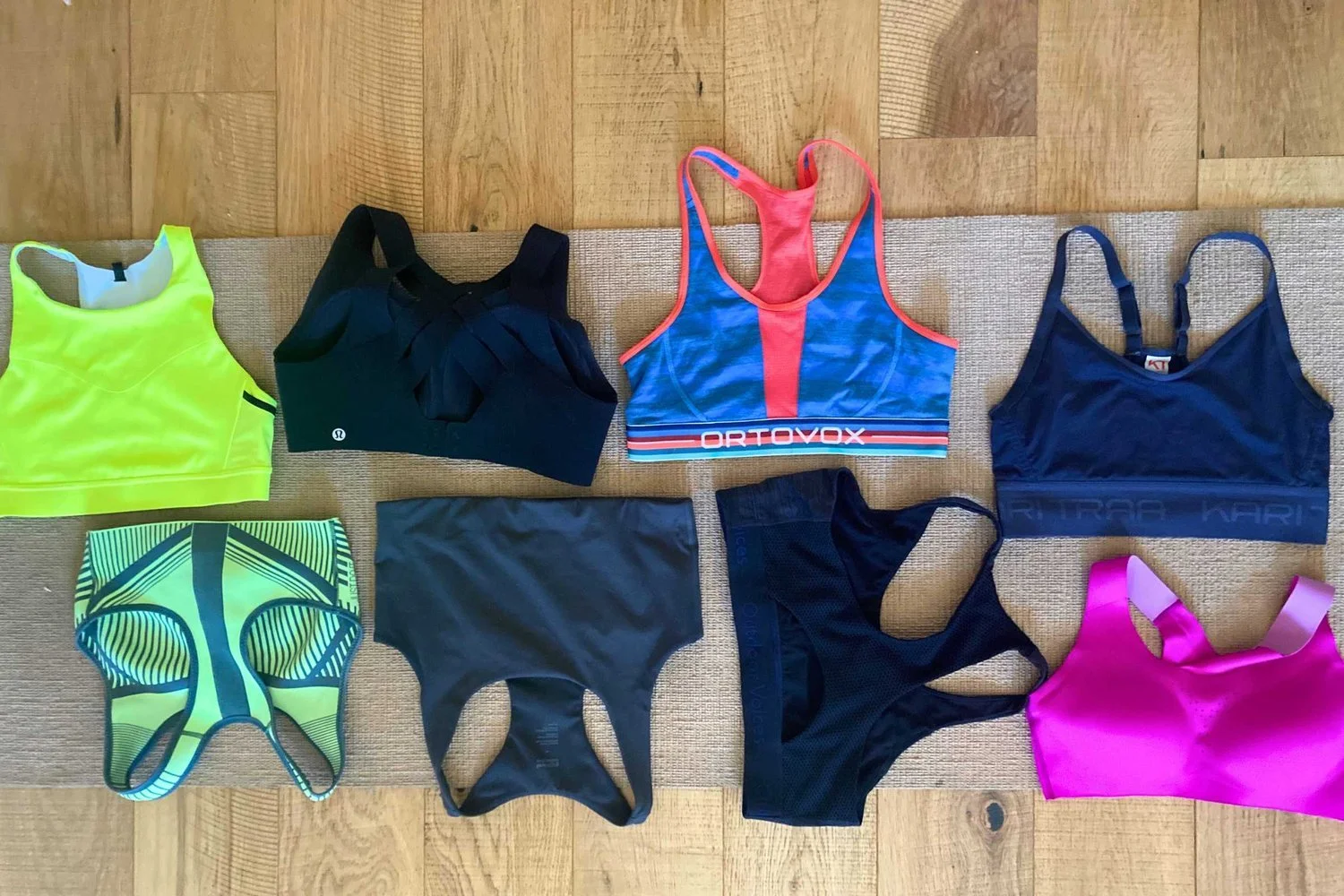 A flat lay collection of various colorful sports bras used during the testing phase.