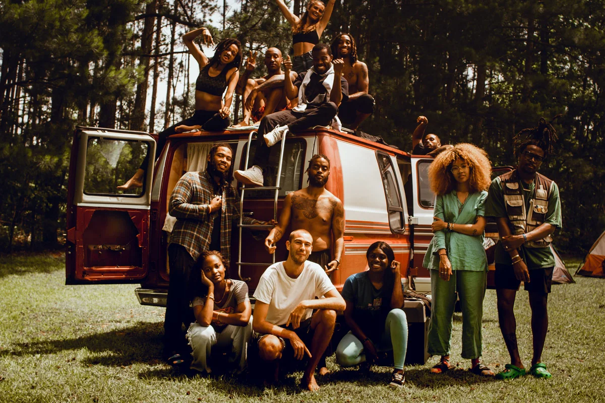 A group of Black participants engaged in a communal camping activity in Georgia.