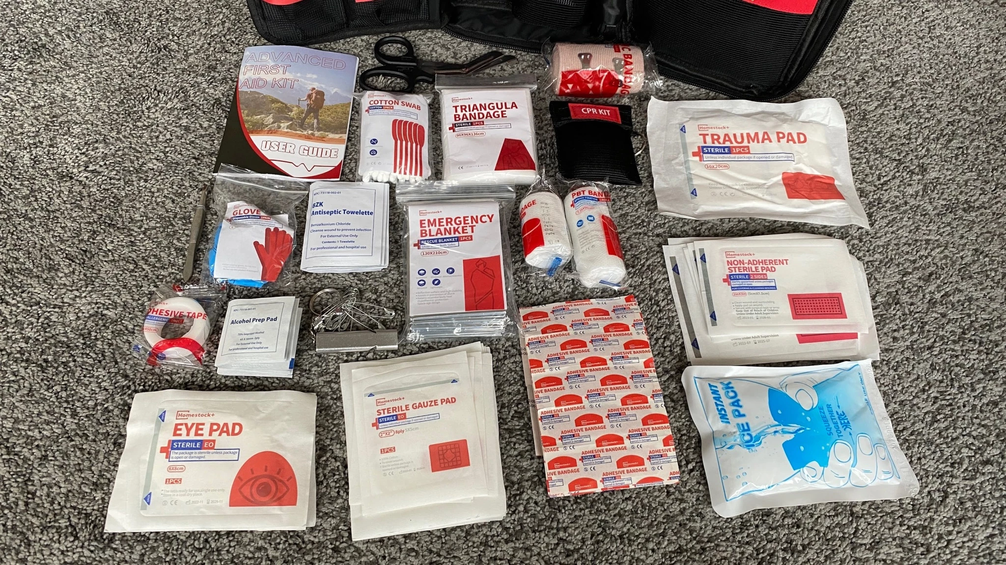 A selection of basic bandages and gauze rolls laid out on a flat surface for a first aid kit.