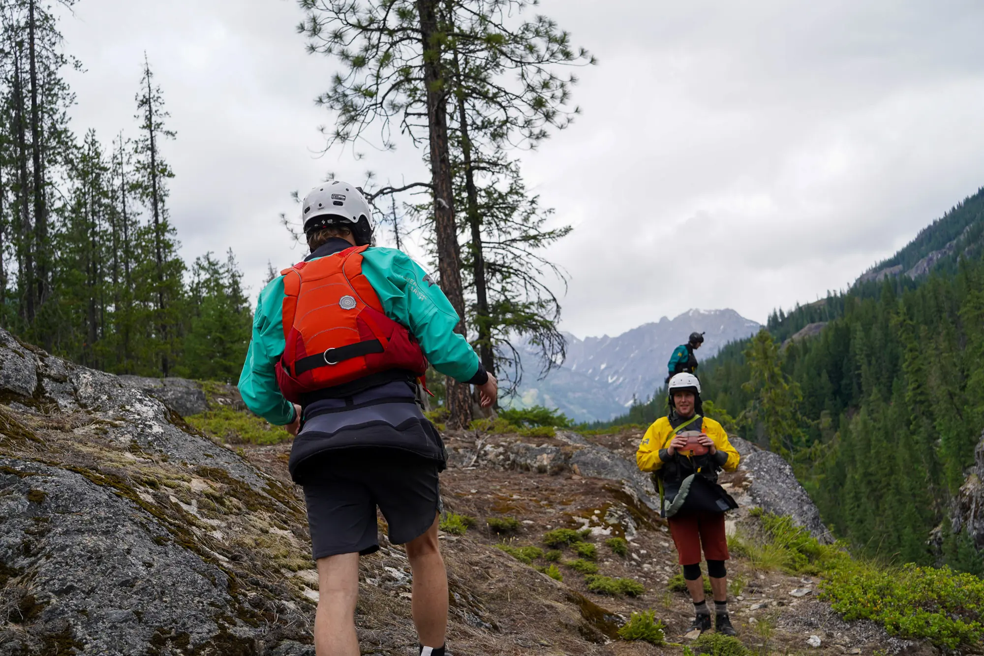 Two paddlers scouting the Stehekin River with their kayaking gear.