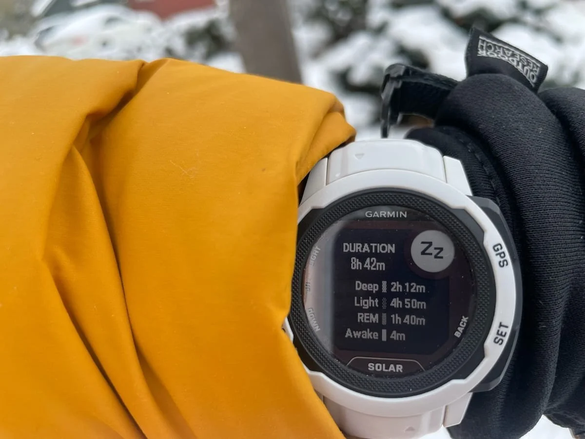 A close-up of a Garmin Instinct 2S Solar smartwatch on a person's wrist during an outdoor excursion.