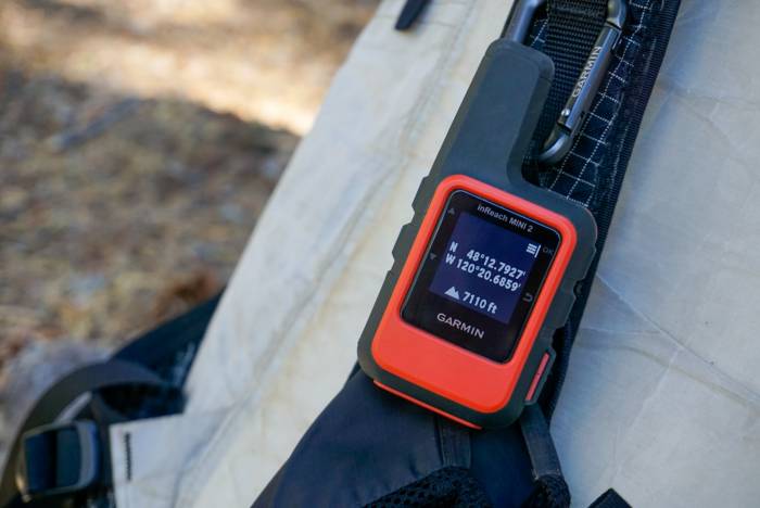 The digital screen of a Garmin inReach Mini 2 showing the Location menu outdoors.