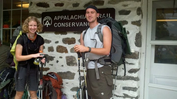 Two hikers on the Appalachian Trail, one wearing a merino wool t-shirt and the other a synthetic shirt.