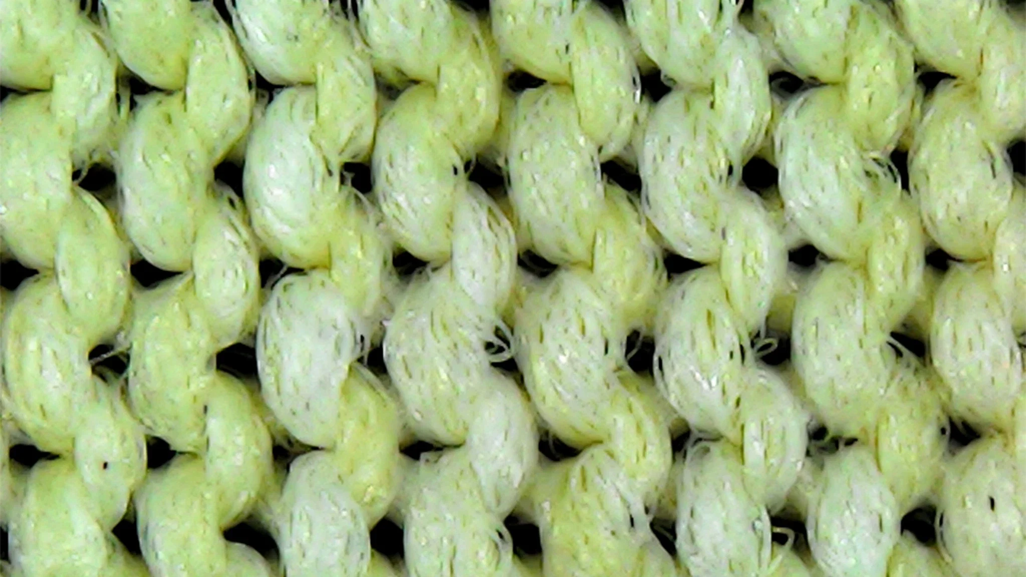Extremely close up view of a tightly knit synthetic fabric block sunlight.
