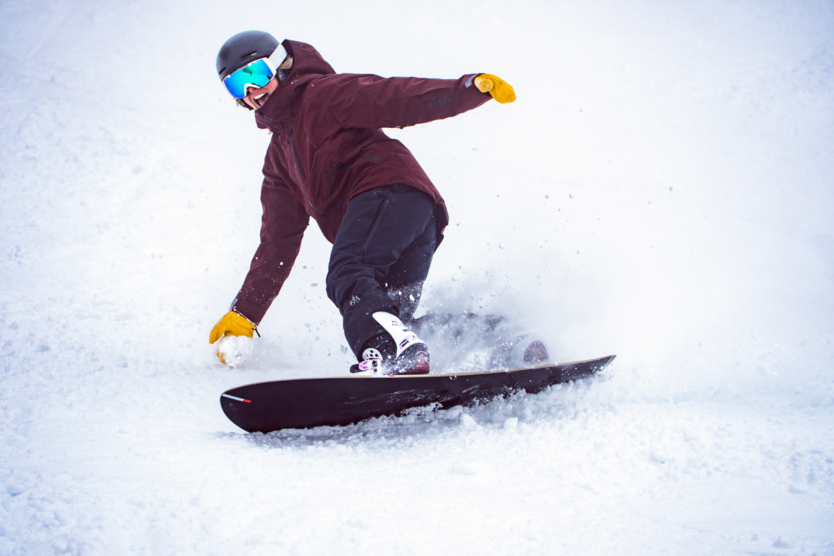 A snowboarder riding down a snowy run at Mission Ridge Resort.