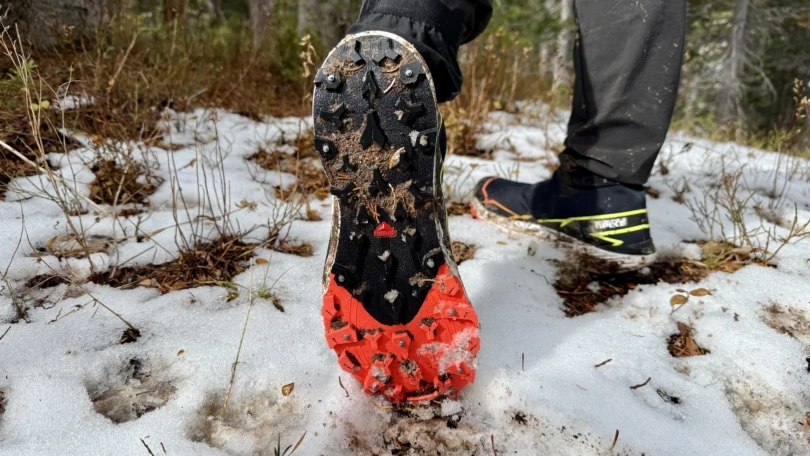 Detailed view of the outsole of the Salomon Winter Cross Spike displaying aggressive lugs and carbide studs.