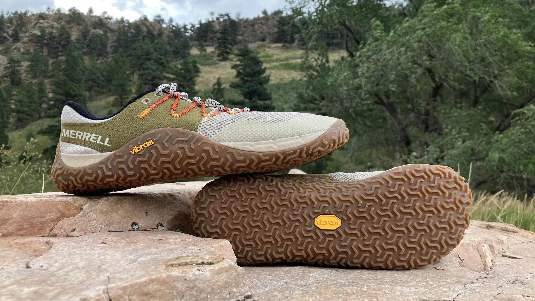 The Merrell Trail Glove 7 being worn on a rocky forest trail.