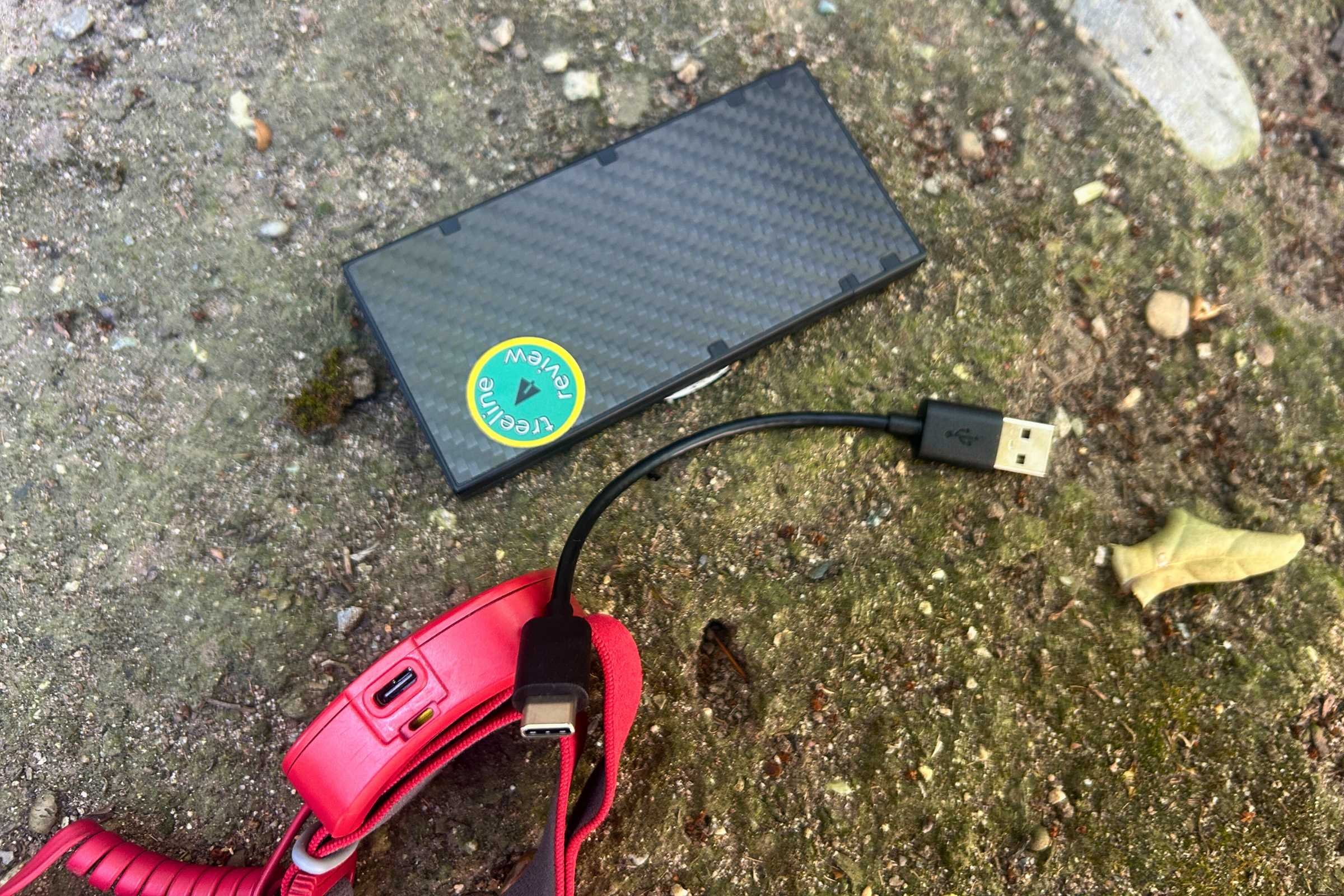 The BioLite Dash 450 headlamp connected to a Nitecore power bank via a USB-C cable.