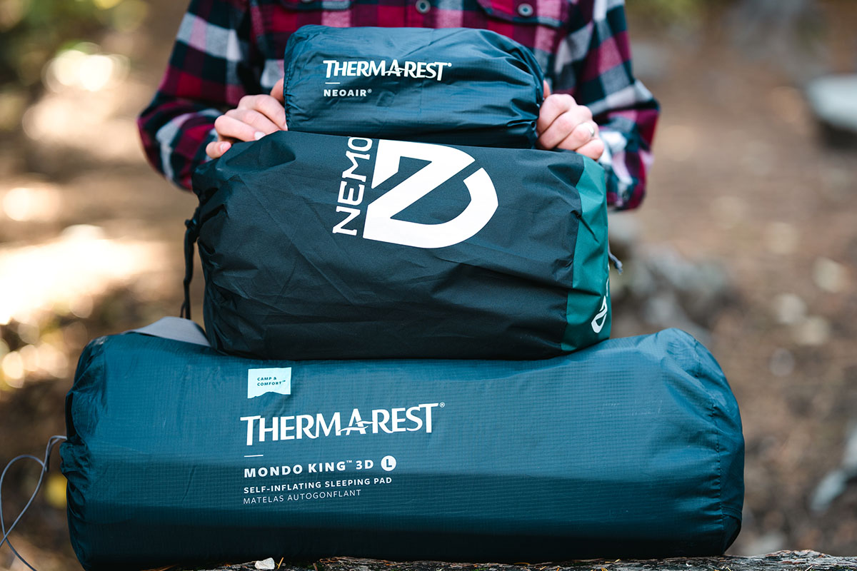 Comparison of different camping mats showing the packed size of the Therm-a-Rest MondoKing 3D against smaller pads.