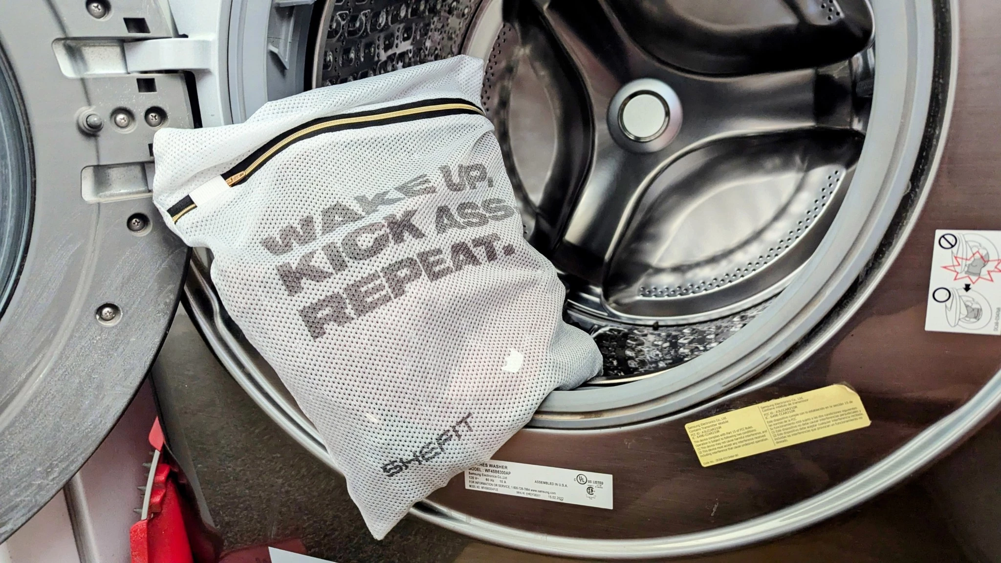 Sports bras placed inside a white mesh laundry bag for protection.