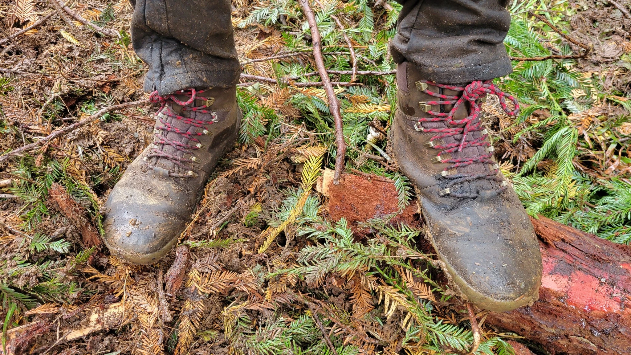 Vivobarefoot Tracker II FG boots in a muddy, outdoor work environment.