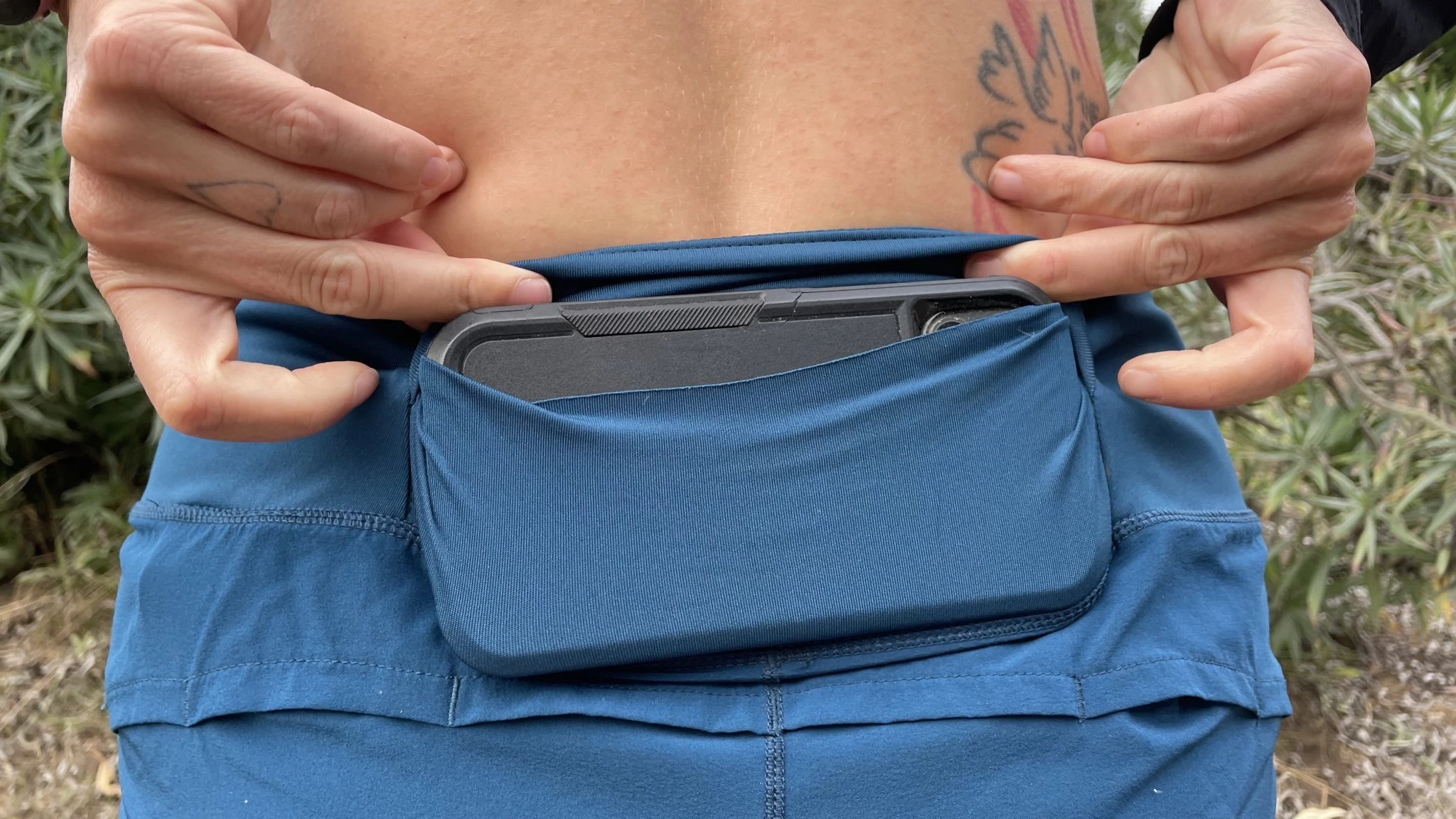 Close-up detail of a rear phone pocket on a pair of Brooks running shorts.