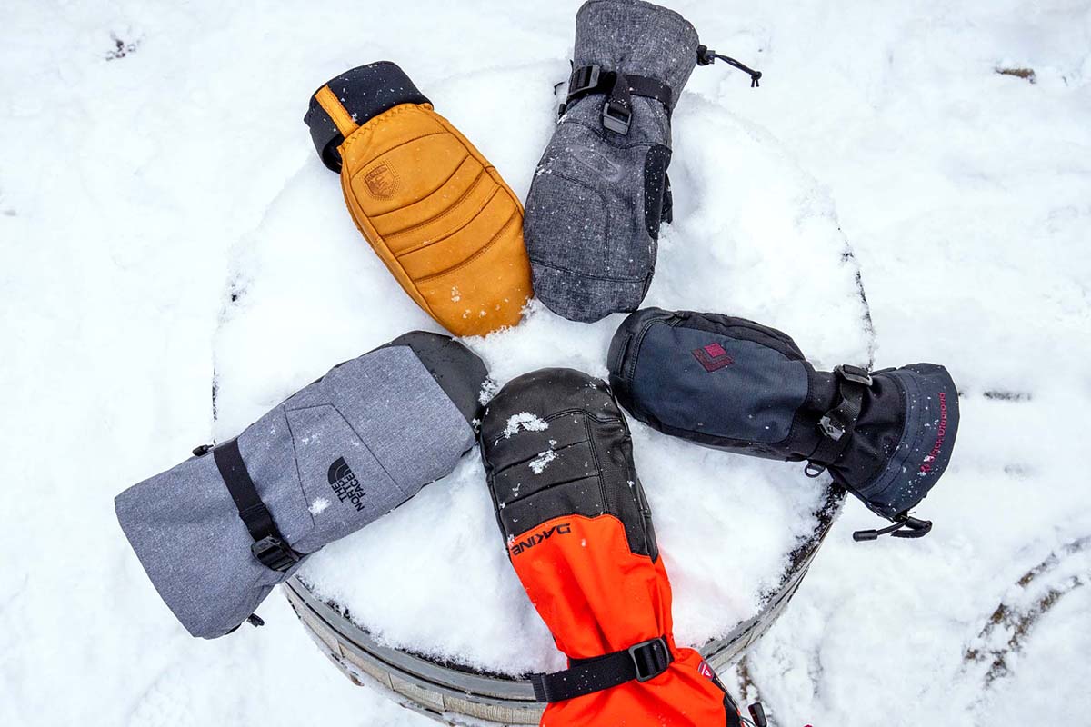 Several different pairs of colorful snowboard mittens arranged in a circle.