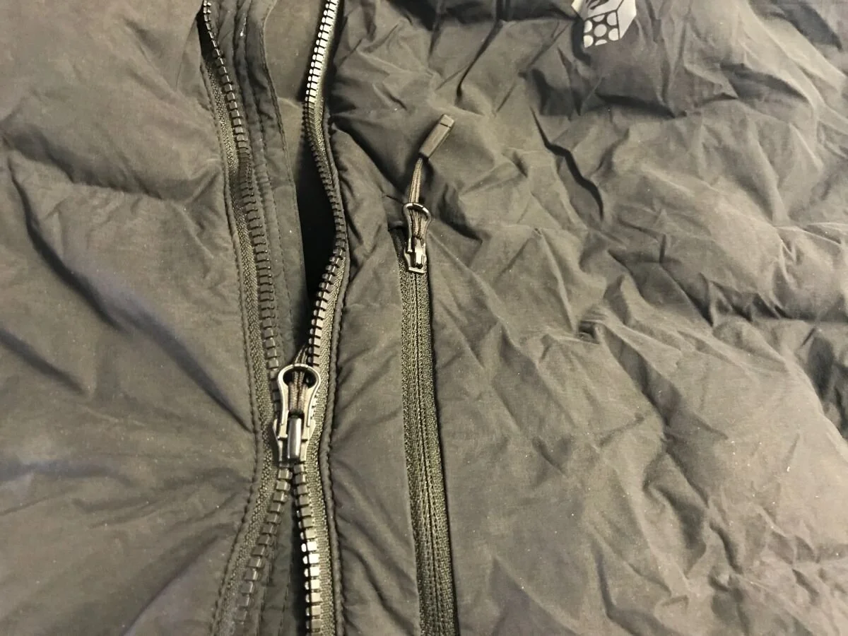 A nylon coil zipper where the teeth are not engaging despite the slider passing over them.