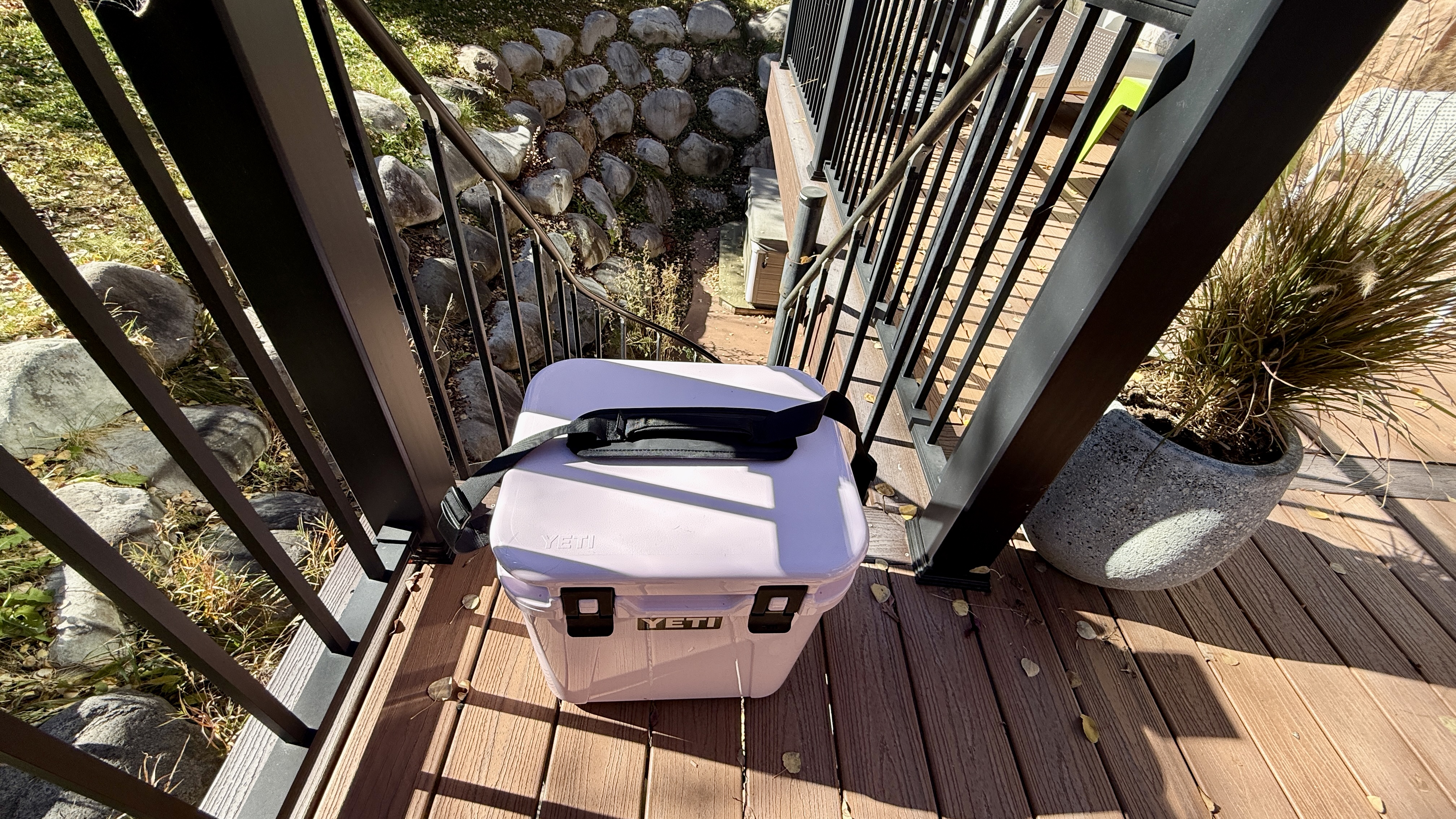 The YETI Roadie 24 sitting at the bottom of a flight of stairs outdoors.