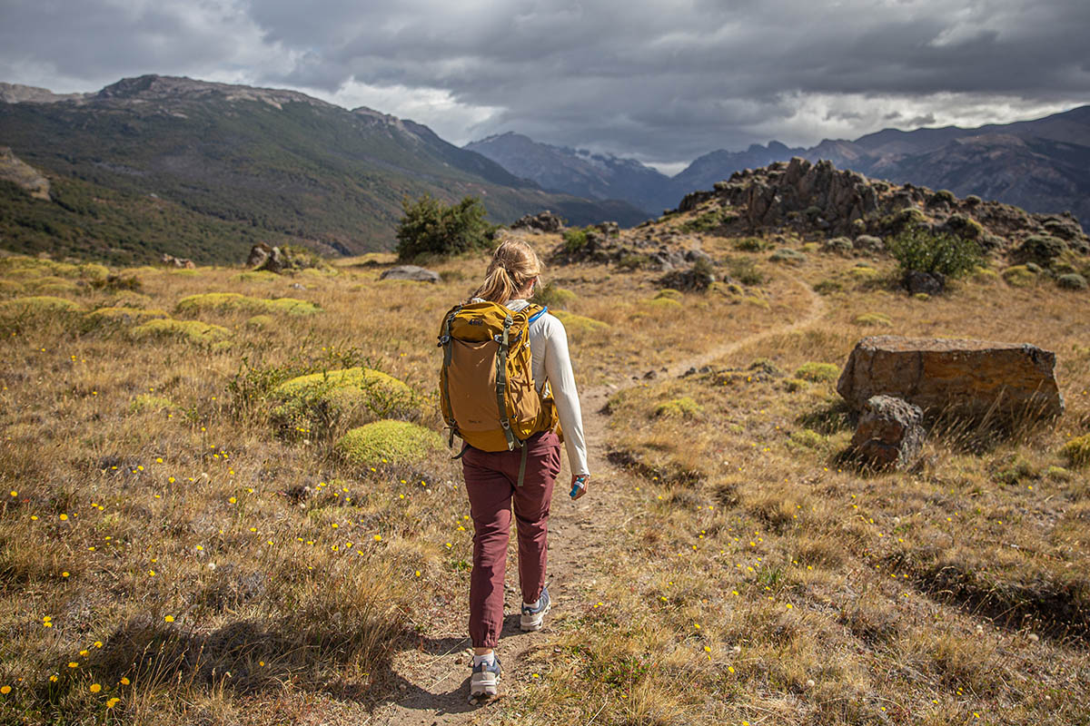 A hiker on a trail in Patagonia wearing the REI Co-op Trail 40 backpack.