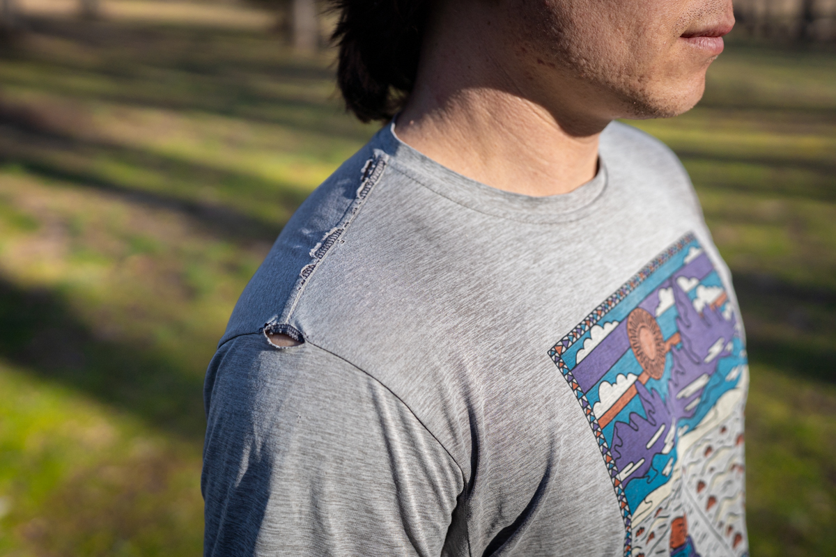 Close-up of a hiking shirt shoulder showing minimal wear after 5,000 miles of use.