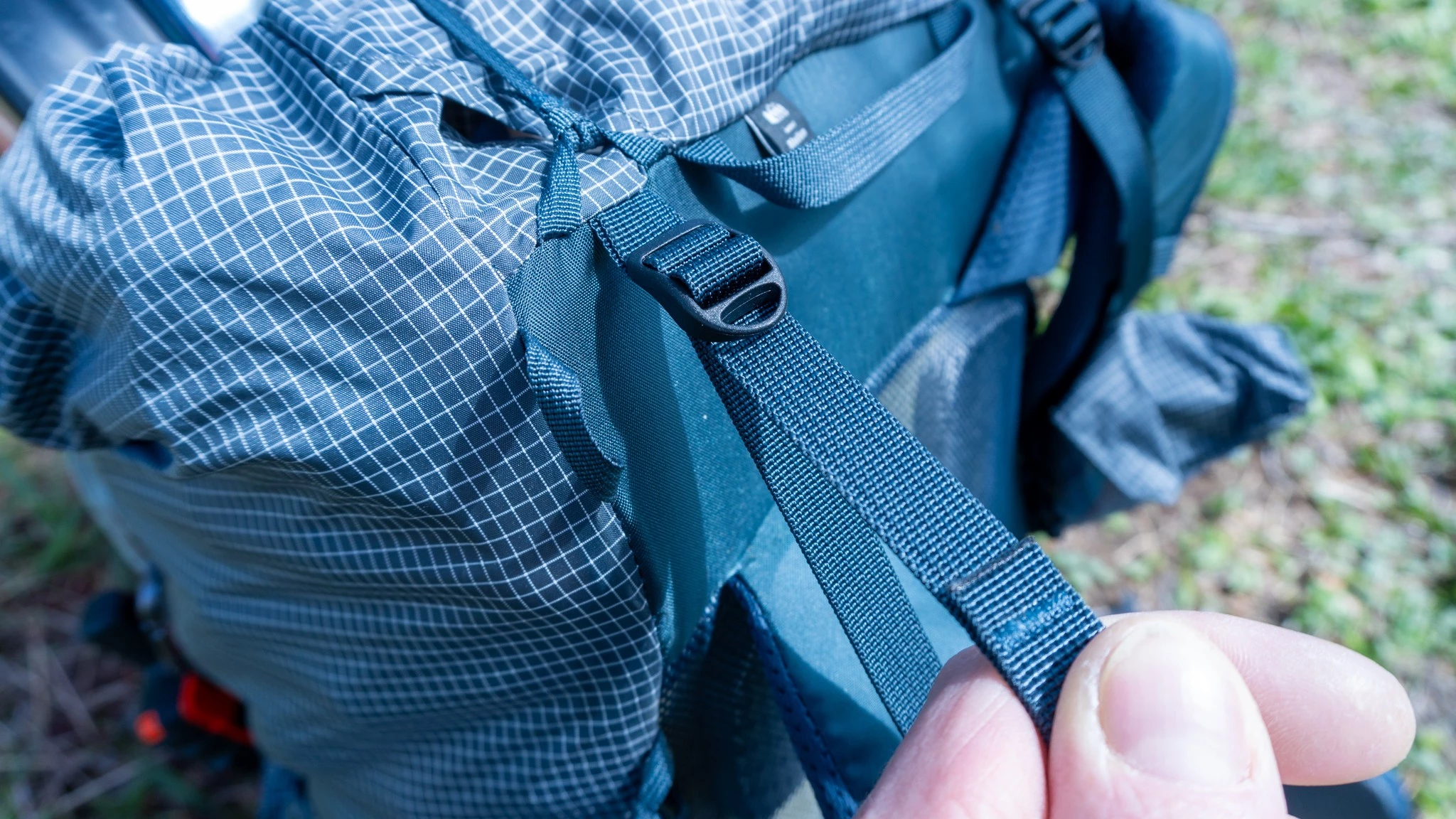 Detail shot of a load lifter strap adjustment on an REI Co-op Flash Air 50 backpack.