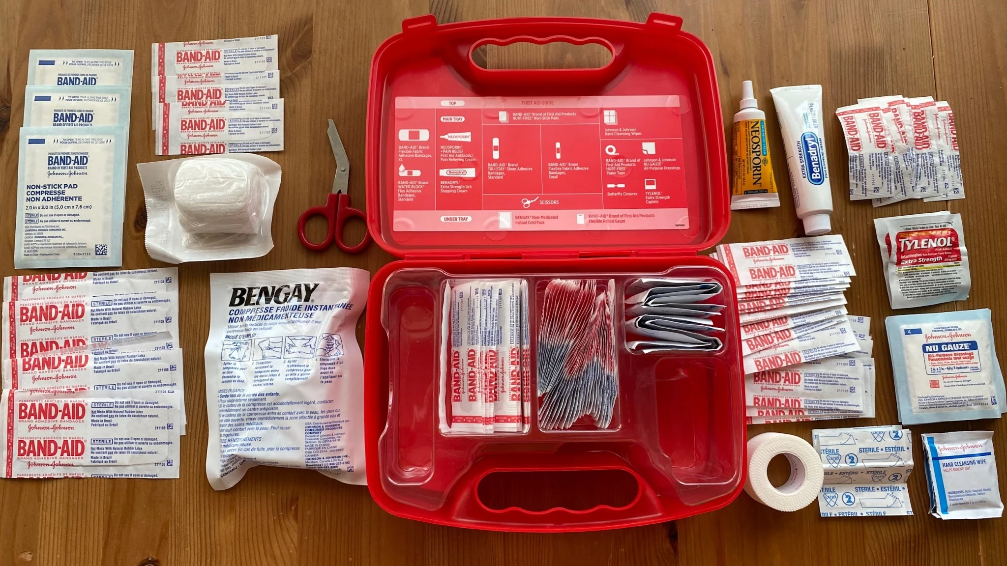 A side-by-side comparison of a heavy-duty home first aid kit and a portable travel kit.