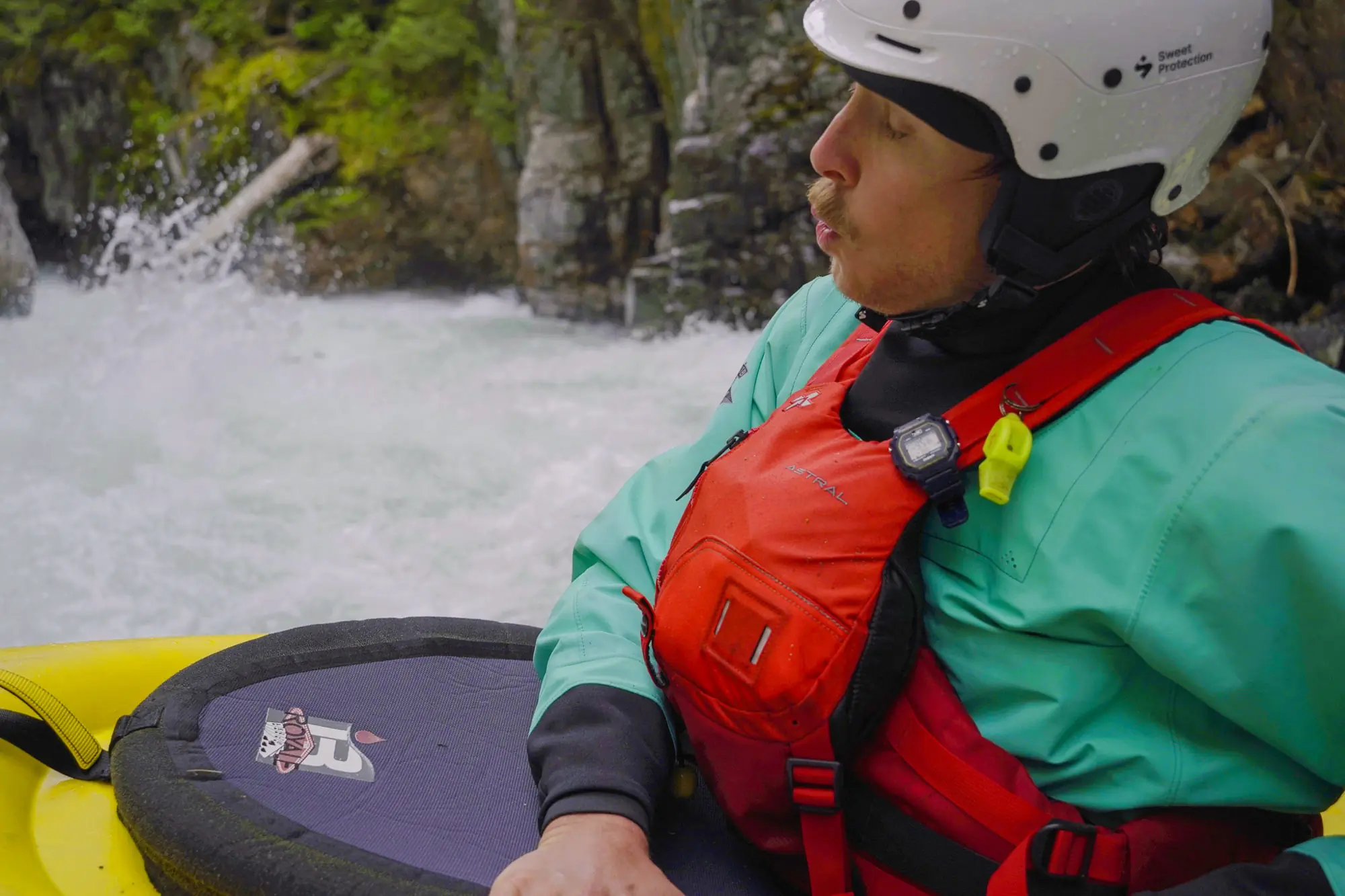 A kayaker wearing an Astral Indus PFD showing the knife mounting location.