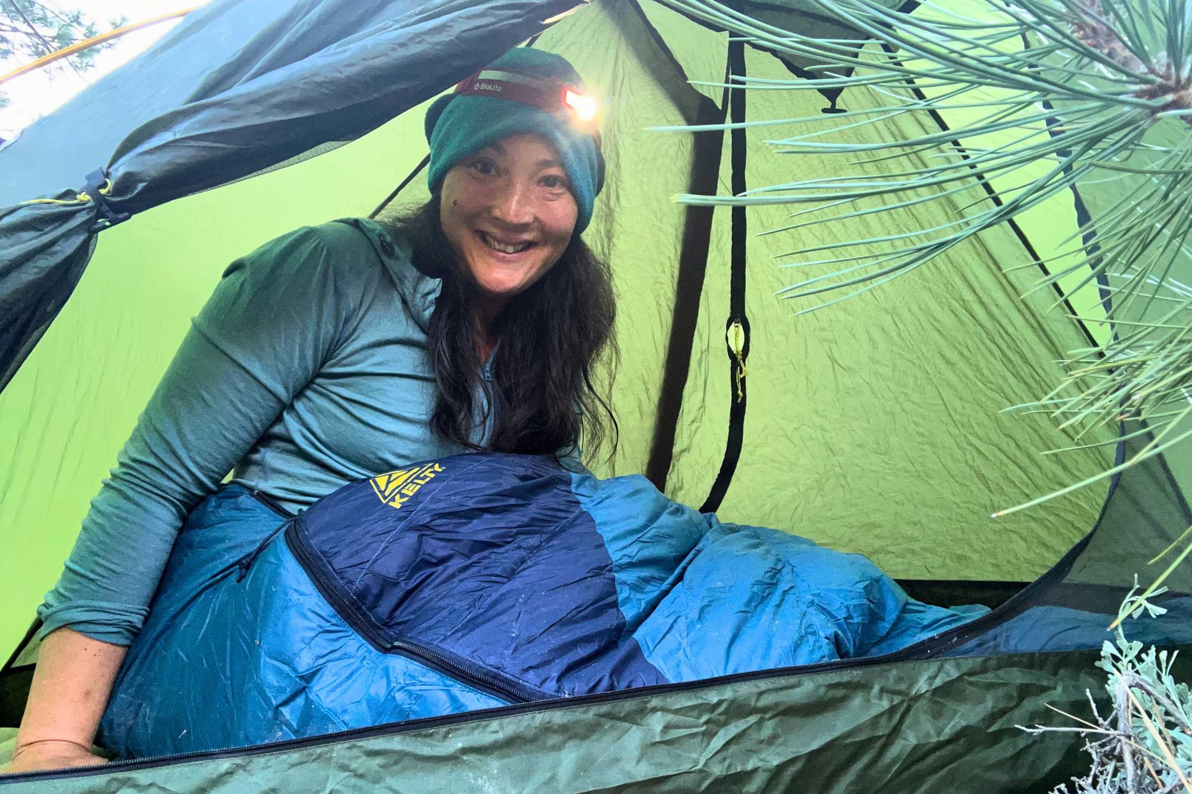 A hiker wearing the BioLite Dash 450 headlamp while backpacking in the Eastern Sierra at dusk.