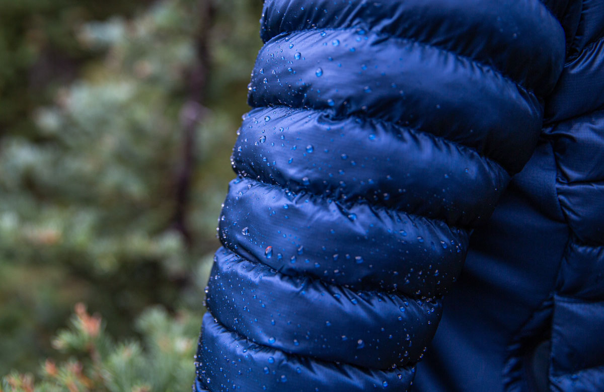 Macro shot of water droplets beading on the DWR-treated shell of a synthetic jacket.