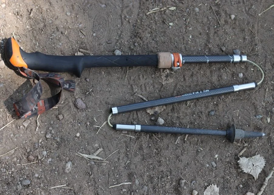 A close-up of a Z-style trekking pole showing the folding segments and internal cord.