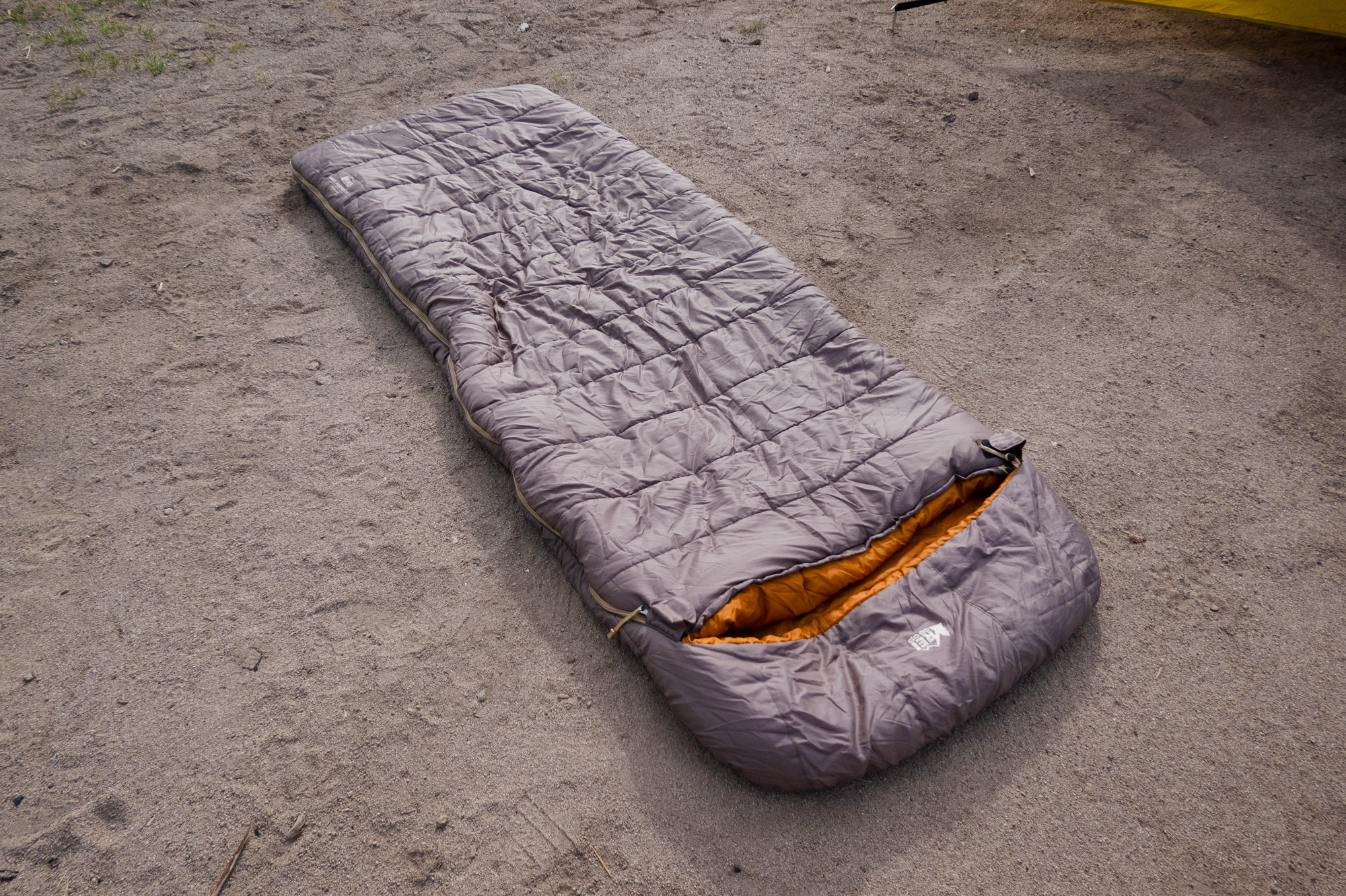 Top down view of the green REI Siesta hooded sleeping bag showing its rectangular shape.