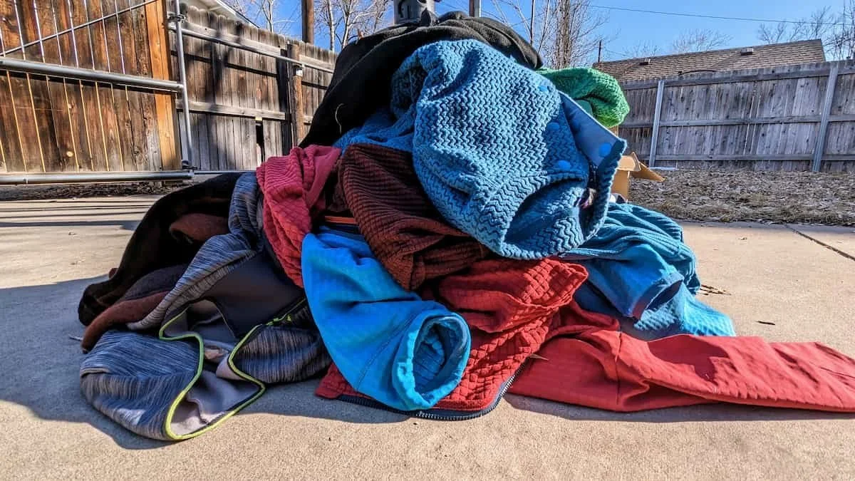 A collection of various outdoor apparel during a testing process for DIY outdoor equipment maintenance.