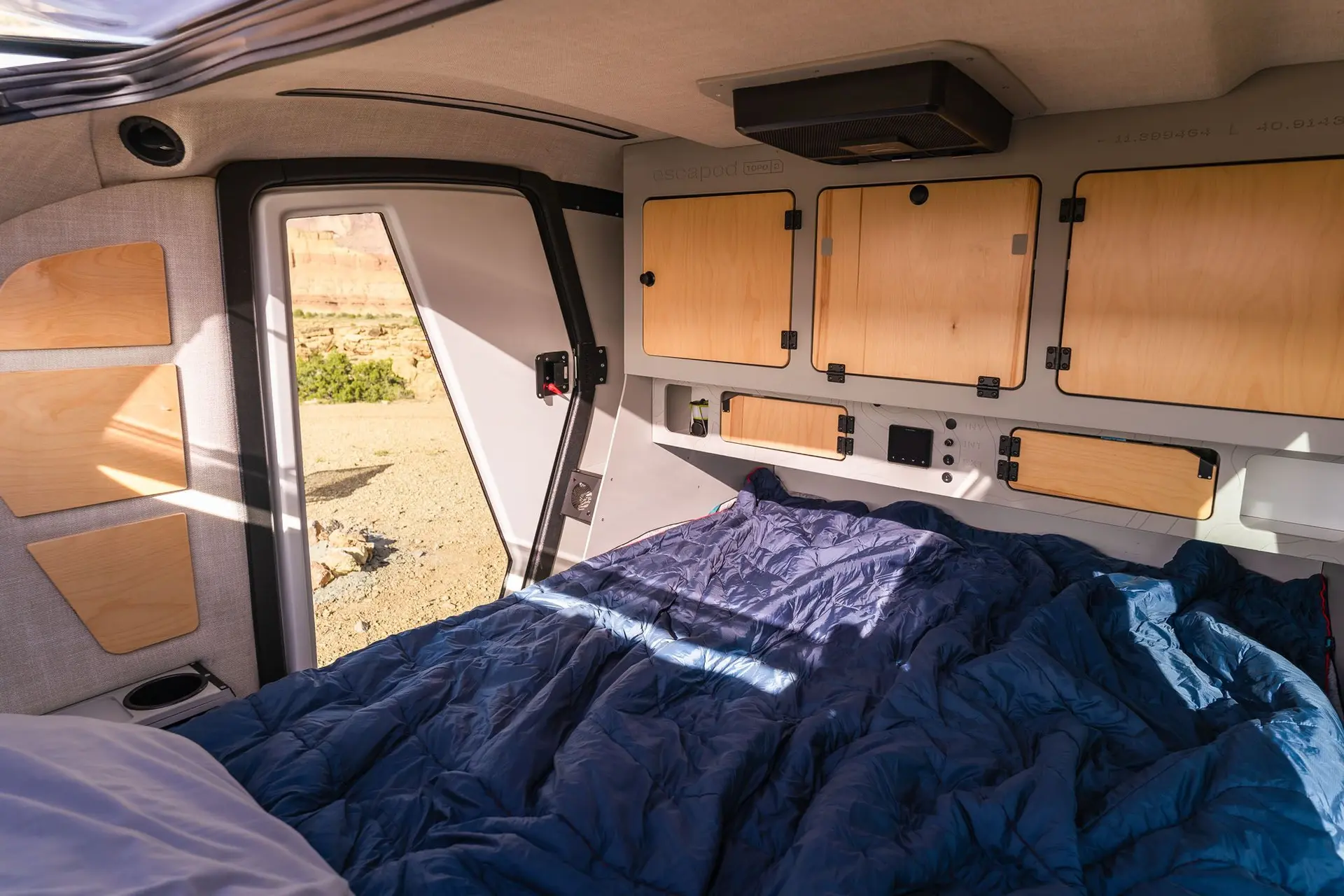 A wide-angle view of the sleeping cabin inside the Escapod TOPO2 MTB trailer.